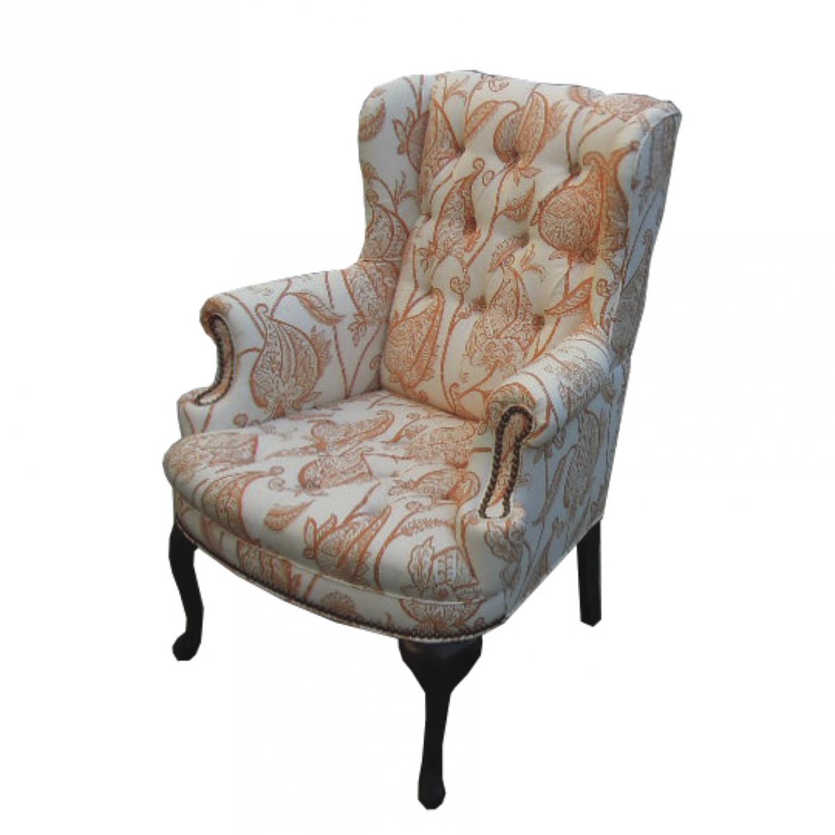 Reupholstered wing chair with tufting in white and orange fabric